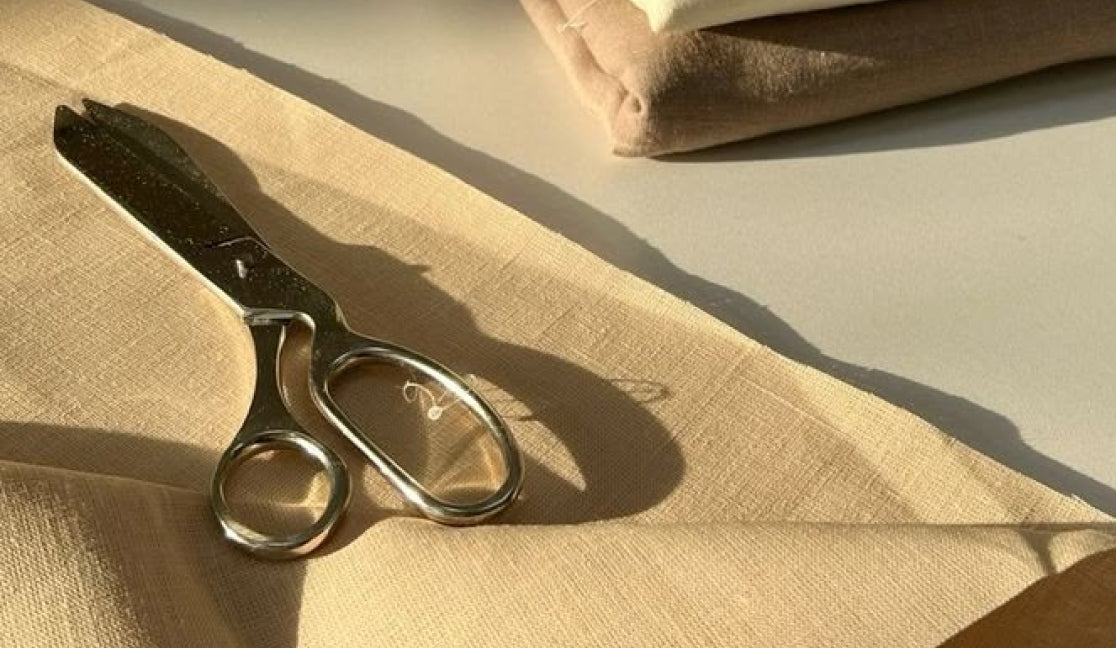 Tailoring scissors resting on neutral fabric